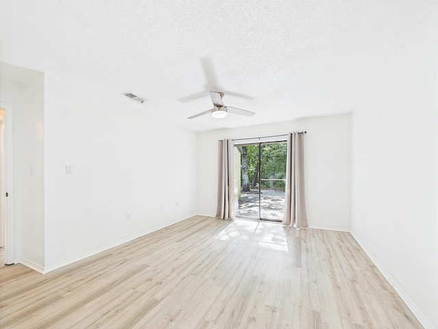 1000 Bay Dr Unit 524, Niceville, FL 32578 - unfurnished room featuring light wood-style floors, ceiling fan, a textured ceiling, and baseboards