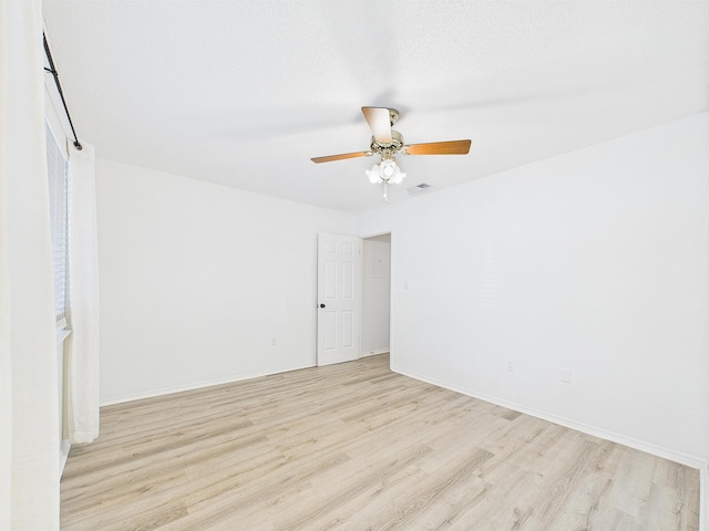 1000 Bay Dr Unit 524, Niceville, FL 32578 - empty room featuring light wood-style flooring, ceiling fan, and baseboards