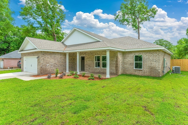 581 Ridge Lake Rd, Crestview, FL 32536 - view of front of house with an attached garage, concrete driveway, brick siding, and central AC