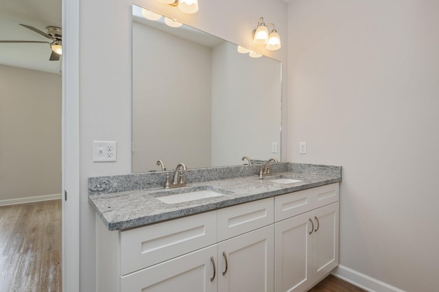 581 Ridge Lake Rd, Crestview, FL 32536 - full bath with wood finished floors, double vanity, baseboards, and a ceiling fan
