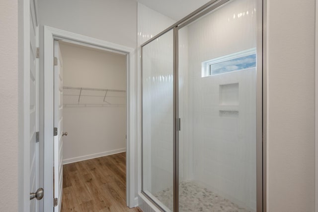 581 Ridge Lake Rd, Crestview, FL 32536 - bathroom with a shower stall, wood finished floors, and a spacious closet