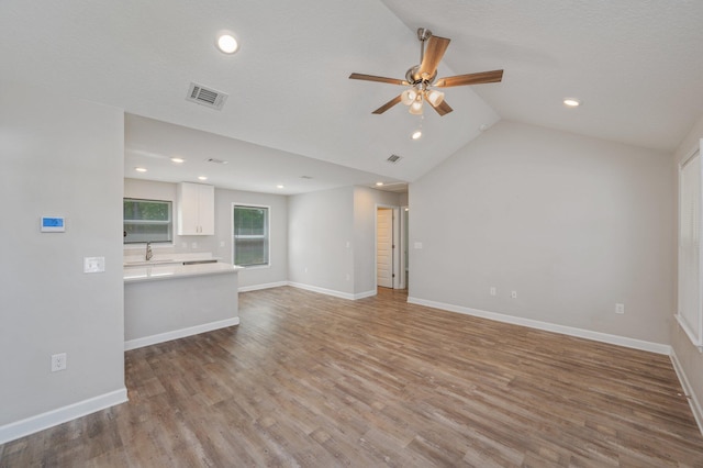 192 S Norwood Rd, Defuniak Springs, FL 32435 - unfurnished living room with lofted ceiling, a ceiling fan, a sink, light wood-style flooring, and recessed lighting