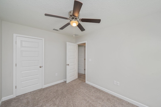 192 S Norwood Rd, Defuniak Springs, FL 32435 - unfurnished bedroom featuring baseboards, carpet flooring, a textured ceiling, and ceiling fan