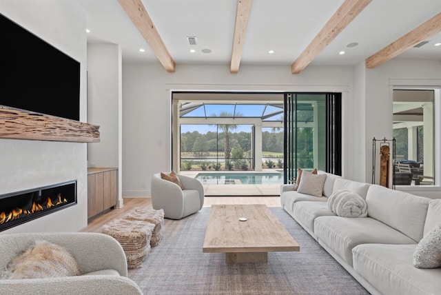 3502 Burnt Pine Ln, Miramar Beach, FL 32550 - living room with a sunroom, wood finished floors, a glass covered fireplace, beamed ceiling, and recessed lighting