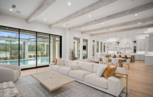 3502 Burnt Pine Ln, Miramar Beach, FL 32550 - living room with light wood finished floors, beamed ceiling, recessed lighting, and a chandelier