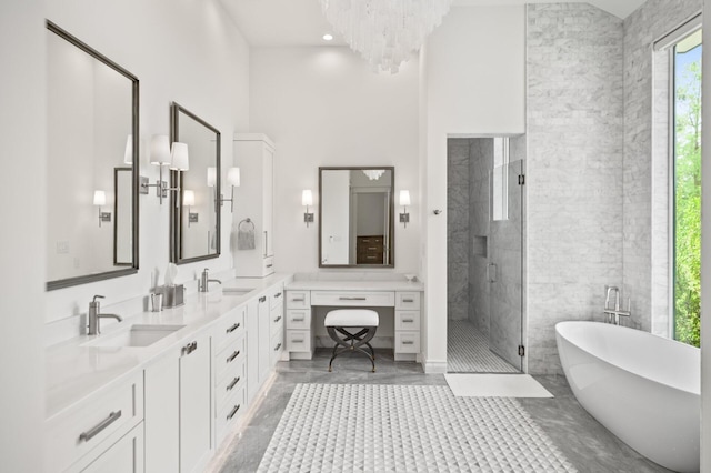 3502 Burnt Pine Ln, Miramar Beach, FL 32550 - bathroom with a freestanding bath, double vanity, a stall shower, a high ceiling, and a chandelier