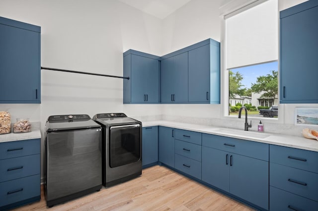 3502 Burnt Pine Ln, Miramar Beach, FL 32550 - washroom with washing machine and clothes dryer, cabinet space, and light wood-style floors