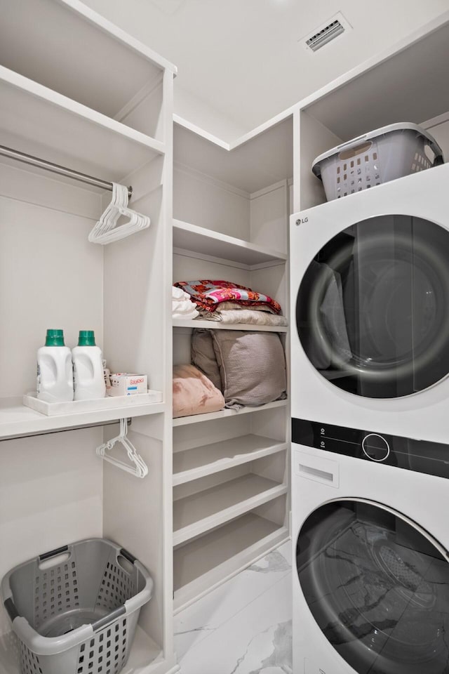 3502 Burnt Pine Ln, Miramar Beach, FL 32550 - laundry area with estacked washer and dryer and marble look tile flooring