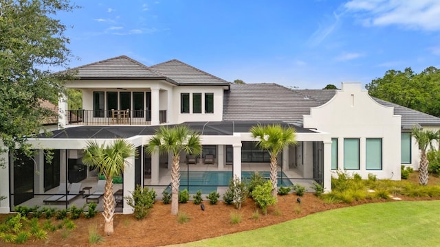 3502 Burnt Pine Ln, Miramar Beach, FL 32550 - back of property with a patio area, a balcony, an outdoor pool, glass enclosure, and a lawn