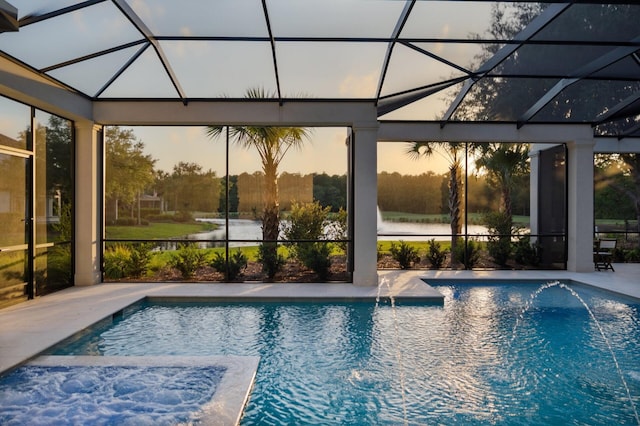 3502 Burnt Pine Ln, Miramar Beach, FL 32550 - pool at dusk with glass enclosure, a patio, and a pool with connected hot tub