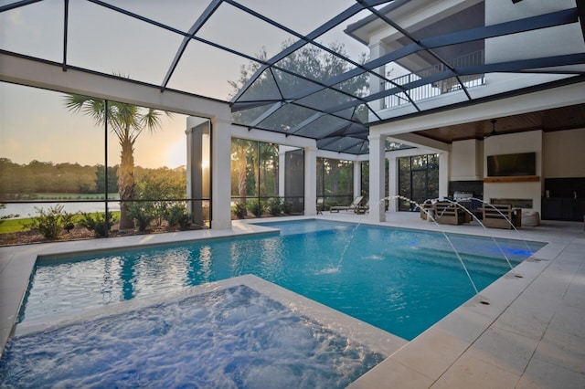 3502 Burnt Pine Ln, Miramar Beach, FL 32550 - pool at dusk with a patio area, a pool with connected hot tub, a lanai, and outdoor lounge area