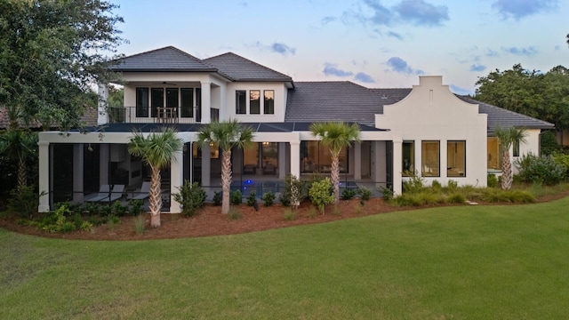 3502 Burnt Pine Ln, Miramar Beach, FL 32550 - back of house featuring a ceiling fan, a lawn, stucco siding, a balcony, and a patio