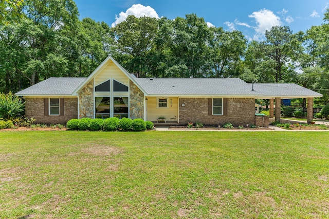 6087 Terrace Ln, Crestview, FL 32536 - view of front of house with a front yard, stone siding, and a shingled roof