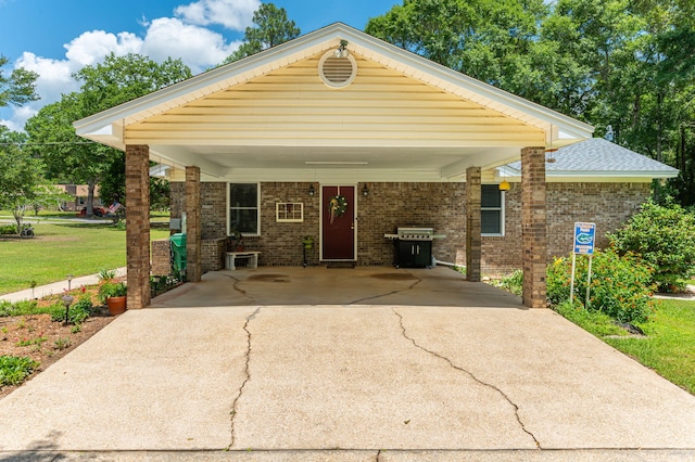 6087 Terrace Ln, Crestview, FL 32536 - view of front of home featuring driveway, a carport, a front yard, and brick siding