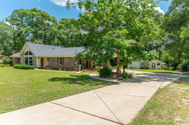 6087 Terrace Ln, Crestview, FL 32536 - view of front of home featuring driveway, brick siding, a front lawn, a chimney, and roof with shingles