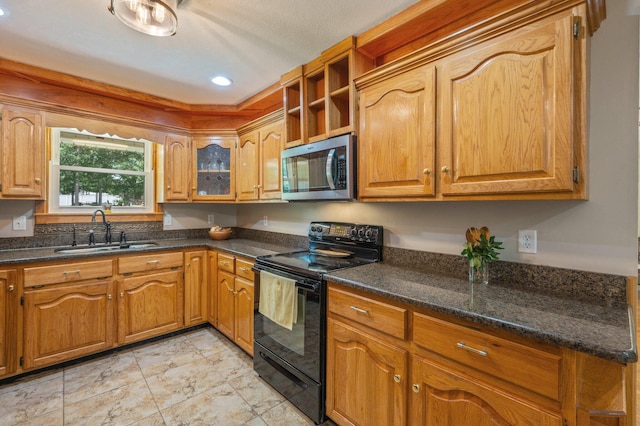 6087 Terrace Ln, Crestview, FL 32536 - kitchen featuring stainless steel microwave, black range with electric cooktop, a sink, recessed lighting, and brown cabinets