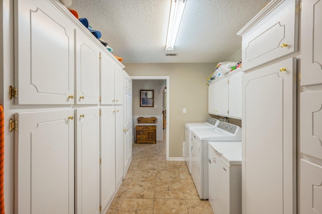 6087 Terrace Ln, Crestview, FL 32536 - washroom featuring washing machine and clothes dryer, cabinet space, a textured ceiling, and baseboards