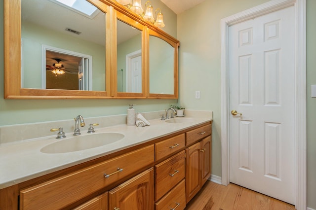 6087 Terrace Ln, Crestview, FL 32536 - full bathroom featuring double vanity, wood finished floors, and ceiling fan