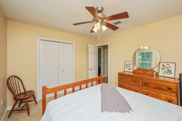 6087 Terrace Ln, Crestview, FL 32536 - bedroom with light colored carpet, a closet, ceiling fan, baseboards, and a textured ceiling