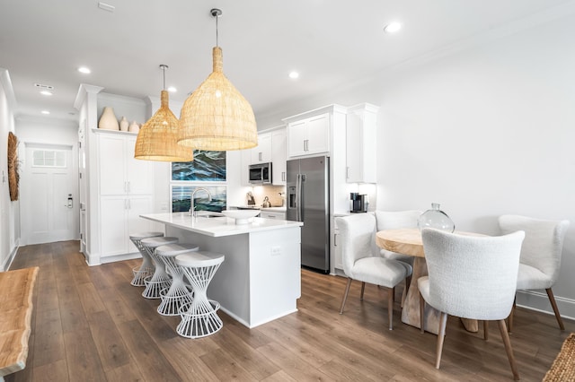 70 Martha S Ln # 2-101, Santa Rosa Beach, FL 32459 - kitchen with appliances with stainless steel finishes, a sink, an island with sink, white cabinets, and a kitchen breakfast bar