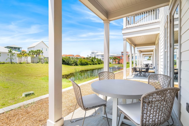 70 Martha S Ln # 2-101, Santa Rosa Beach, FL 32459 - view of patio / terrace with outdoor dining area, a water view, a balcony, and a residential view