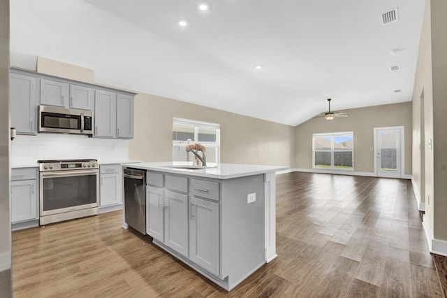 262 Bayou Bend Ln, Panama City, FL 32404 - kitchen with appliances with stainless steel finishes, gray cabinets, light countertops, ceiling fan, and lofted ceiling