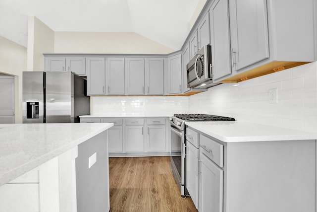 262 Bayou Bend Ln, Panama City, FL 32404 - kitchen with appliances with stainless steel finishes, gray cabinetry, light countertops, and lofted ceiling
