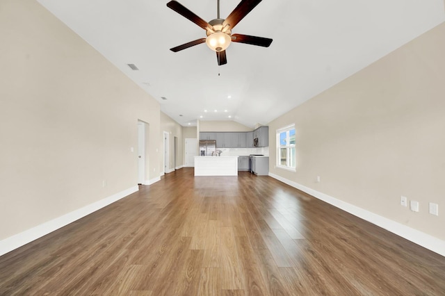 262 Bayou Bend Ln, Panama City, FL 32404 - unfurnished living room featuring lofted ceiling, a ceiling fan, wood finished floors, and baseboards