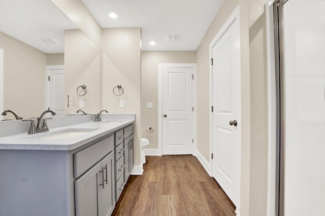 262 Bayou Bend Ln, Panama City, FL 32404 - full bath with toilet, wood finished floors, double vanity, and baseboards