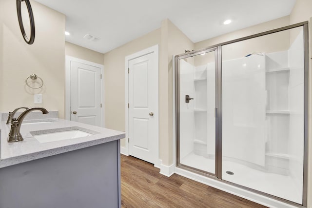 262 Bayou Bend Ln, Panama City, FL 32404 - full bathroom featuring a shower stall, wood finished floors, baseboards, double vanity, and recessed lighting