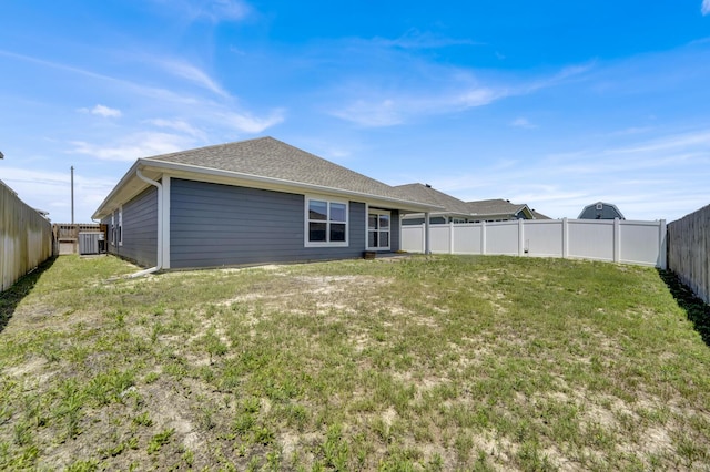 262 Bayou Bend Ln, Panama City, FL 32404 - back of house with central AC unit and a shingled roof