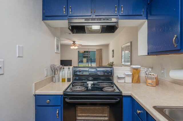 115 NE Hughes St Unit B3, Fort Walton Beach, FL 32548 - kitchen with black electric range, blue cabinetry, under cabinet range hood, light countertops, and ceiling fan