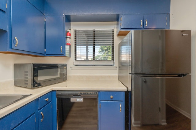 115 NE Hughes St Unit B3, Fort Walton Beach, FL 32548 - kitchen with black appliances, blue cabinets, light countertops, and a sink