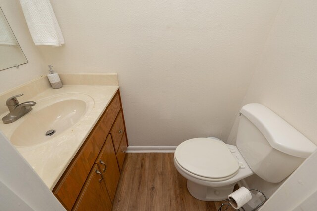 115 NE Hughes St Unit B3, Fort Walton Beach, FL 32548 - bathroom with wood finished floors, vanity, baseboards, and toilet