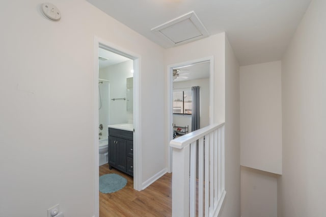 115 NE Hughes St Unit B3, Fort Walton Beach, FL 32548 - hallway featuring light wood-style flooring, attic access, and baseboards