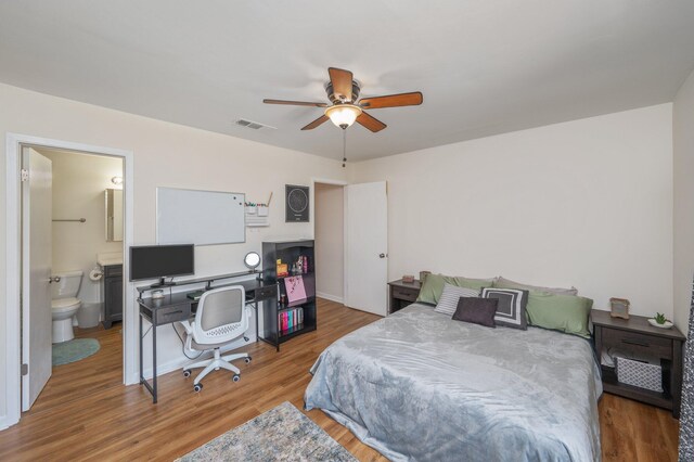 115 NE Hughes St Unit B3, Fort Walton Beach, FL 32548 - bedroom with wood finished floors, an office area, connected bathroom, a ceiling fan, and baseboards
