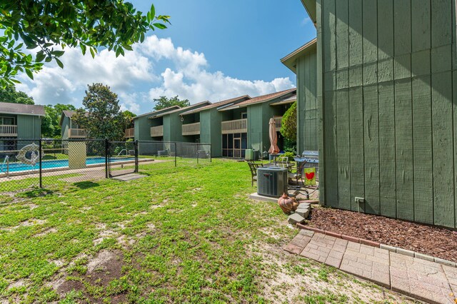 115 NE Hughes St Unit B3, Fort Walton Beach, FL 32548 - view of yard featuring central air condition unit and a community pool