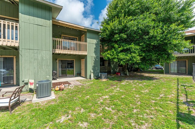 115 NE Hughes St Unit B3, Fort Walton Beach, FL 32548 - view of grassy yard with a balcony and central AC