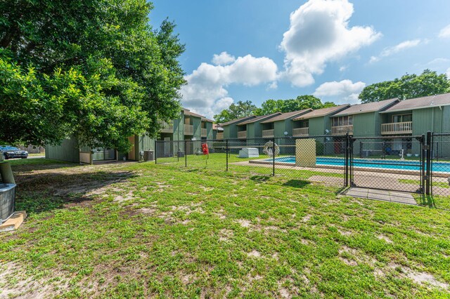 115 NE Hughes St Unit B3, Fort Walton Beach, FL 32548 - view of yard featuring a community pool, a residential view, and cooling unit