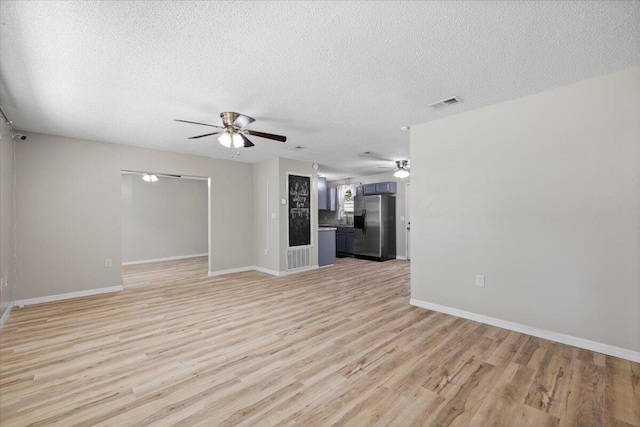1008 Aspen Ct, Fort Walton Beach, FL 32547 - unfurnished living room featuring a ceiling fan, light wood finished floors, baseboards, and a textured ceiling