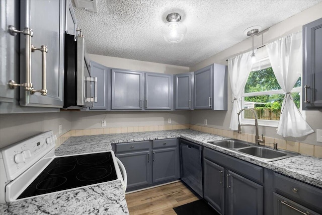 1008 Aspen Ct, Fort Walton Beach, FL 32547 - kitchen with white electric range oven, black dishwasher, a sink, light countertops, and a textured ceiling