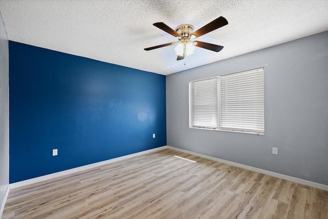 1008 Aspen Ct, Fort Walton Beach, FL 32547 - spare room with wood finished floors, a ceiling fan, a textured ceiling, and baseboards