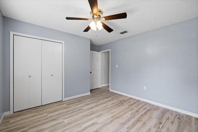 1008 Aspen Ct, Fort Walton Beach, FL 32547 - unfurnished bedroom with wood finished floors, a closet, baseboards, ceiling fan, and a textured ceiling