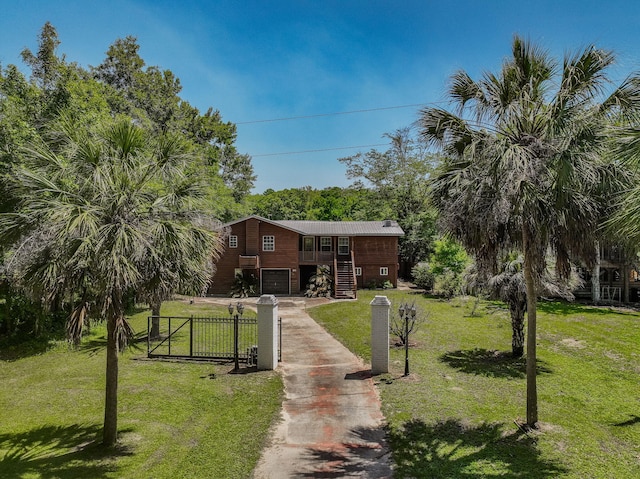 891 Choctawhatchee River Rd, Ponce De Leon, FL 32455 - view of yard with a garage, concrete driveway, and stairs