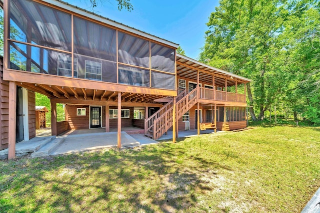 891 Choctawhatchee River Rd, Ponce De Leon, FL 32455 - rear view of house featuring a sunroom, a patio area, a yard, stairway, and a wooden deck