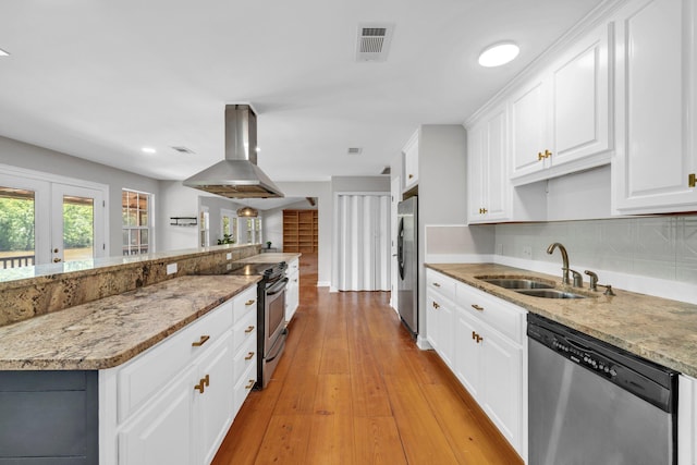 891 Choctawhatchee River Rd, Ponce De Leon, FL 32455 - kitchen featuring appliances with stainless steel finishes, island range hood, a sink, and white cabinetry
