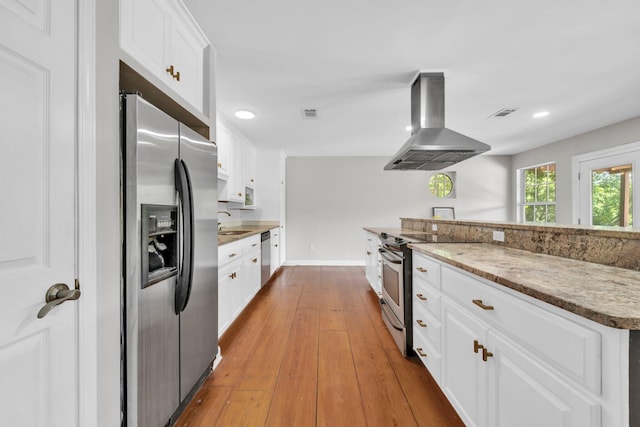 891 Choctawhatchee River Rd, Ponce De Leon, FL 32455 - kitchen featuring appliances with stainless steel finishes, ventilation hood, white cabinets, wood-type flooring, and recessed lighting