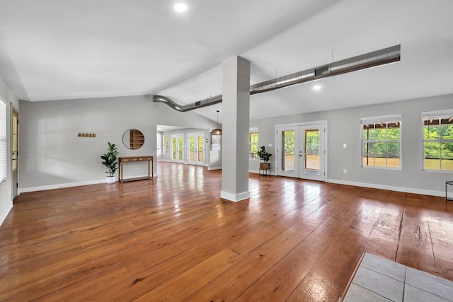 891 Choctawhatchee River Rd, Ponce De Leon, FL 32455 - unfurnished living room featuring lofted ceiling, hardwood / wood-style flooring, healthy amount of natural light, baseboards, and french doors