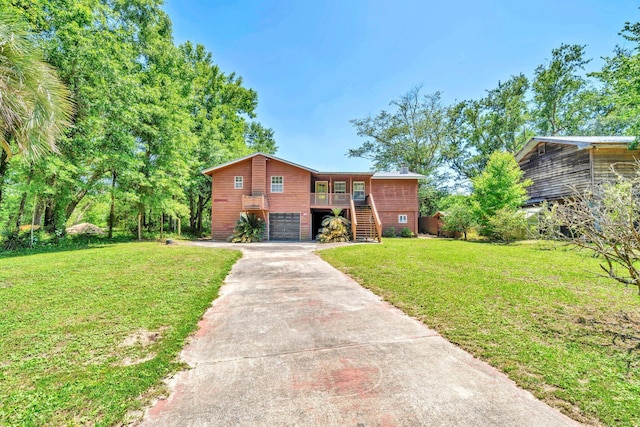 891 Choctawhatchee River Rd, Ponce De Leon, FL 32455 - view of front of property featuring stairway, concrete driveway, a garage, and a front yard
