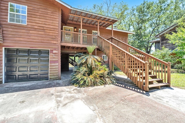 891 Choctawhatchee River Rd, Ponce De Leon, FL 32455 - rear view of house with stairs, a garage, and driveway